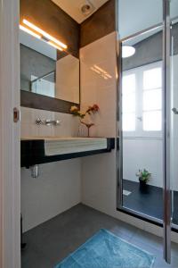 a bathroom with a sink and a mirror at La Casita del Mar in Sitges