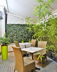
a garden area with a table and chairs at Hotel Astoria Sure Hotel Collection By Best Western in Milan

