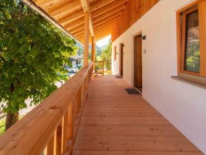 a wooden walkway leading to the porch of a house at Kurzenwirt - Ferienwohnungen in Kiefersfelden