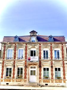 a large brick building with a sign on it at LE JABLOIRE in Florent-en-Argonne