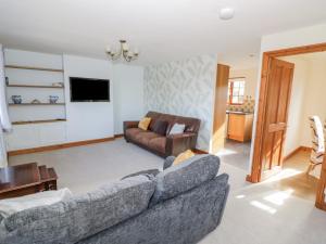 a living room with a couch and a table at Avon View in Stratford-upon-Avon