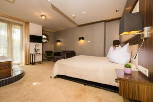 Voodi või voodid majutusasutuse Duna Garden Hotel toas
