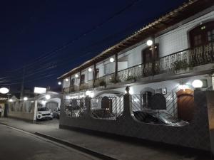 a building with a balcony on the side of it at Pousada Caravelas in Paraty