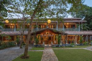 a home with a large building with a porch at Green Escape Unawatuna in Unawatuna