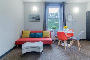 a living room with a couch and a table at Remaotel Seafield Court Apartments in Great Yarmouth +29 photos