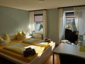 a bedroom with two beds and a desk and a television at Deutscher Kaiser in Lauchringen