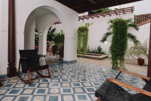 a patio with two chairs and a plant at Rouge By La Gran Francia in Granada