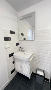 a white bathroom with a sink and a mirror at Maple Lodge in Braşov +26 photos