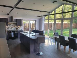 a kitchen with a table and chairs in a room at willow tree farm cottage with BBQ hut in Tattershall Thorpe