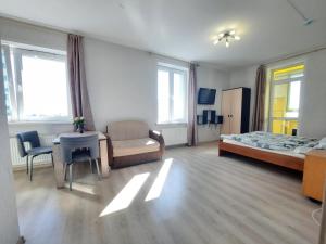 a hotel room with a bed and a table and a chair at K&K Apartments Gulliver 146 in Perm