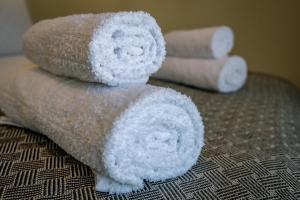 two rolls of toilet paper sitting on a bed at Miracle Luxury Apartments in Perea +82 photos