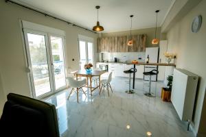 a kitchen with a table and chairs in a room at Miracle Luxury Apartments in Perea