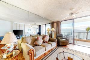 a living room with a couch and a television at Lauloa Resort 303 in Wailuku