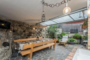 a bedroom with a wooden bed and a stone wall at Agritur E-Cinque in Salorno