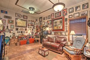 a living room with a leather couch and pictures on the wall at Romantic Villa with Courtyard, 2 Blocks to Riverwalk in San Antonio