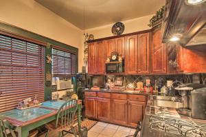 a kitchen with wooden cabinets and a table with a tableablish at Romantic Villa with Courtyard, 2 Blocks to Riverwalk in San Antonio