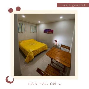a bedroom with a bed and a wooden table at Un rincón en las Sierras in Sierra de los Padres