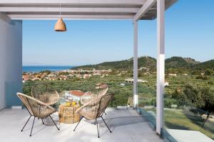 a patio with two chairs and a table with a view at Hillside Villa - Thea in Limenas
