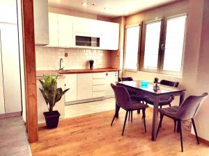 a kitchen and dining room with a table and chairs at BJANKA Square Apartments Skopje in Skopje