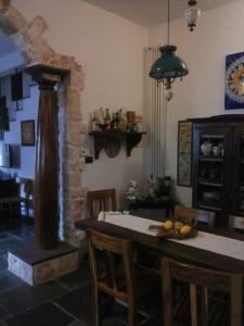 a kitchen with a table with chairs and a stove at B&B Govinda Shanty House in Gorgofreddo