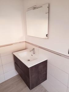 a bathroom with a sink and a mirror at Cava Resort Costa d'Amalfi in San Pietro