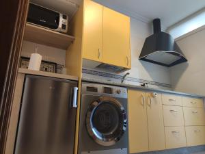a kitchen with a washing machine and a stove at Harritarte in Getaria