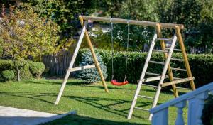 a playground with a swing and a ladder at Odisea Hill House - Modern Holiday Home with swimming pool, sauna, jacuzzi, WiFi and 2 bedrooms, near Varazdin in Gačice