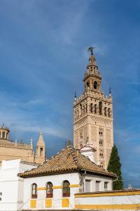 a building with a clock tower in the background at Historic Building Cathedral in Seville