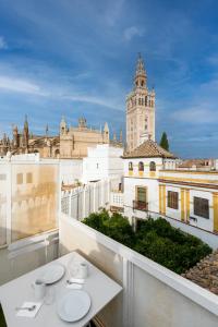 a balcony with a view of a building with a clock tower at Historic Building Cathedral in Seville