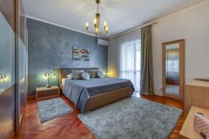 a bedroom with a bed and a large window at Adria House Dubrovnik by the sea in Zaton