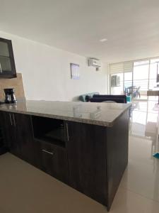 a kitchen with a counter top in a room at Departamento frente al mar, FONTAINE BLEAU in Tonsupa