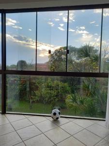 a soccer ball sitting on the floor in front of a window at Caiowa Floripa guesthouse in Florianópolis