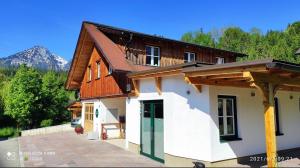 a house with a wooden roof and a patio at Ferienhaus Borth in Altaussee