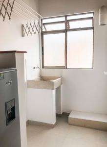 a kitchen with a sink and a window at Portal del Rodeo ApartaHotel in Medellín