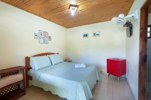 Cama ou camas em um quarto em Pousada Aconchego