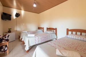 Cama ou camas em um quarto em Pousada Aconchego