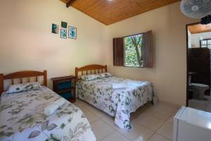 Cama ou camas em um quarto em Pousada Aconchego