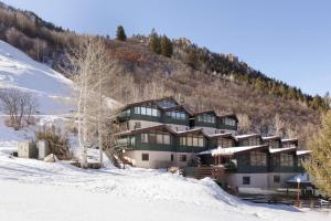 a large building on a snow covered mountain at Shadow Mountain 14 in Aspen