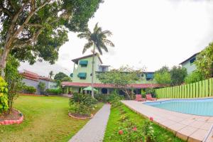a house with a swimming pool in front of a yard at VOA Pousada Dos Jasmins in Serra