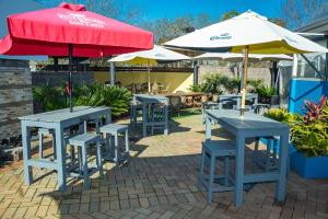 a group of tables and chairs with umbrellas at Peppermill Inn Motel in Shepparton