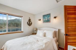 a bedroom with a bed and a window at Howard's Lakehouse by the Sea in Rockaway Beach