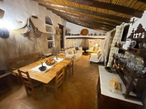 a living room with a wooden table and a couch at Monte Abaixo in Almodôvar