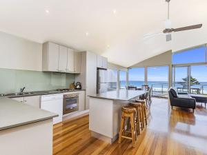 an open kitchen and dining room with a view of the ocean at Shemara in Port Fairy