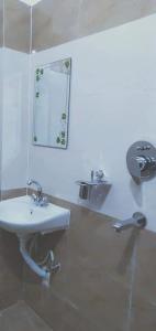a bathroom with a sink and a mirror at Hotel Kanthak in Rummindei