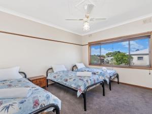 a room with two beds and a window at Kepal House in Port Fairy