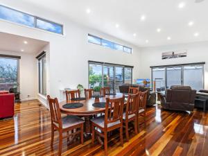 an open living room with a table and chairs at Shore Shanks in Port Fairy