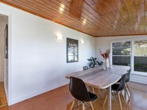 a dining room with a wooden table and chairs at Avery Cottage in Port Fairy