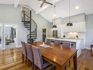 a kitchen and dining room with a wooden table and chairs at East Tempy House and Bungalow in Port Fairy