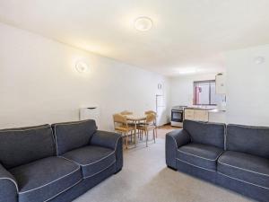 a living room with two couches and a table at Eastern Beach Unit 3 in Port Fairy