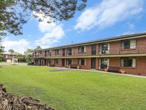 a large brick building with a lawn in front of it at Eastern Beach Unit 3 in Port Fairy
